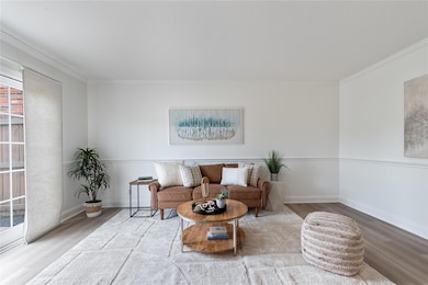 Sitting room featuring wood finished floors and o