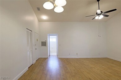 Spare room with light wood finished floors, a chan