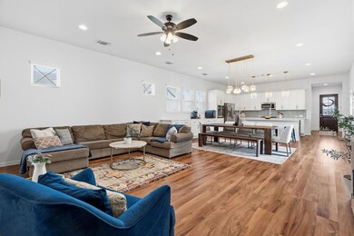 The oversized living area overlooks the dining area and kitchen.