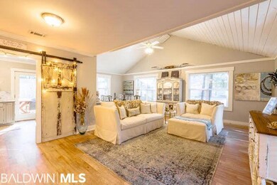 INVITING GREAT ROOM WITH BARN DOOR LEADING INTO KITCHEN