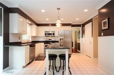 The kitchen includes a large center island with br