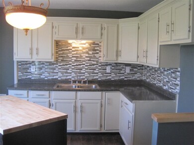 The kitchen offers an island and bar overlooking t
