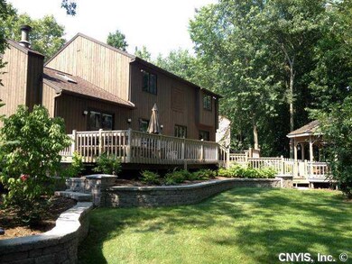 Exterior Back. Tastefully landscaped along retaini