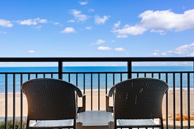 Balcony with a view of the beach and a water view