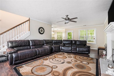 Living area featuring wood finished floors, stairs