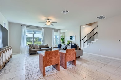 Living area featuring a ceiling fan, baseboards, 
