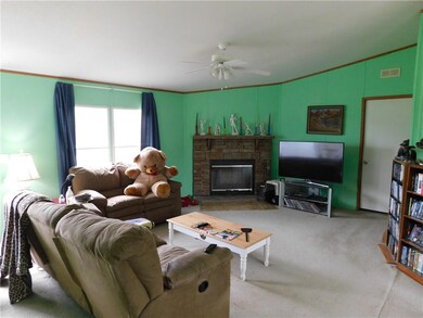Spacious living room with wood burning fireplace. 