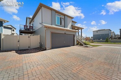 View of front of house featuring a balcony and a g