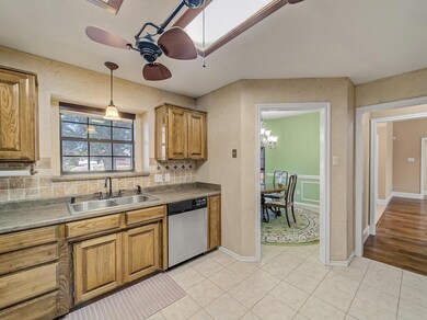 Kitchen with ceiling fan with notable chandelier, 