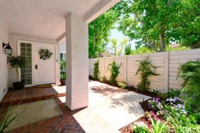 A Gated Courtyard Entry  with beautiful landscapin