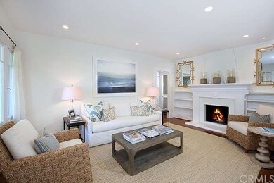 Living room with built in cabinets & wood burning 
