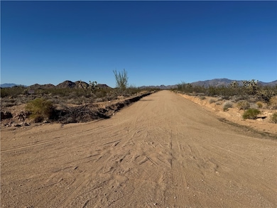 View of dirt / gravel road featuring a mountain view