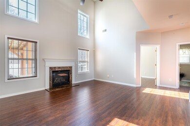 2 Story Great Room has tons of natural light & features gas fireplace, lighted ceiling fan.