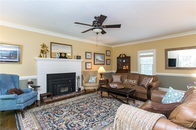 Living Room (21x15): Hardwood floor, ceiling fan, woodstove
