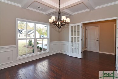 Study w/ detailed coffered ceiling, wainscoting. f