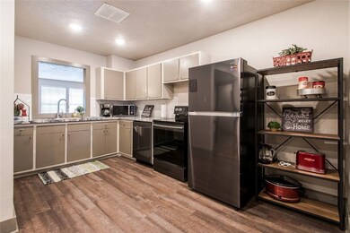 Kitchen featuring visible vents, black appliances,
