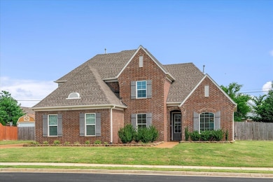 Traditional-style house featuring brick siding and a shingled roof
