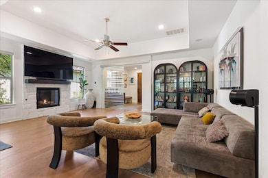 Living room featuring visible vents, a tray ceili