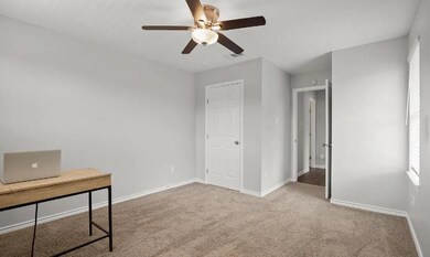 Unfurnished office with a ceiling fan, baseboards