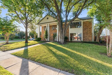 Neoclassical / greek revival house with a front ya