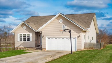 View of front of home with a front lawn and a garage