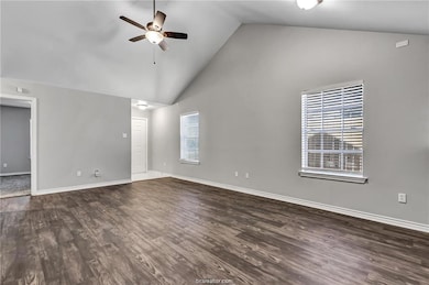 Unfurnished living room featuring a ceiling fan, h