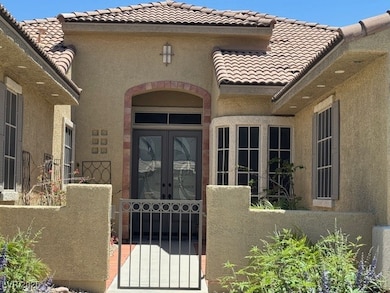 Property entrance with french doors, a tile roof,