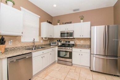 Upgraded kitchen with travertine floors, newer sta