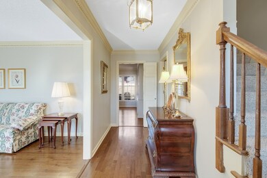 The stunning Foyer opens to the living room, den ,