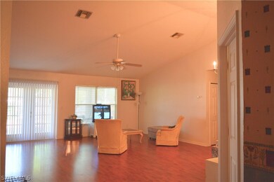 Great room with French doors to oversized screened patio. The cathedral ceiling adds to the size of the room