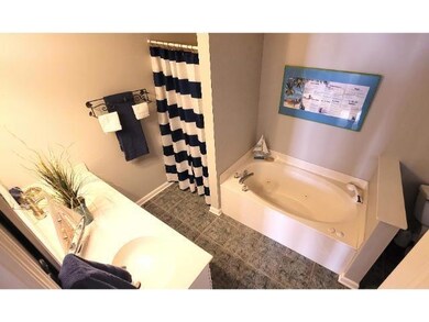 Bathroom with tile patterned flooring and a washtu