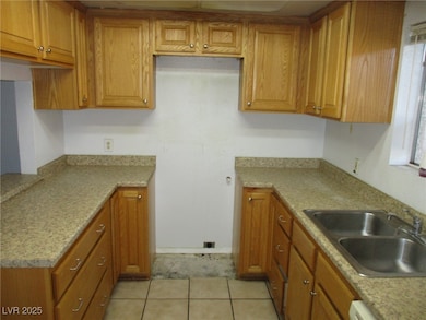 Kitchen featuring brown cabinets, light countertop