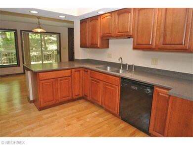 The remodeled kitchen has cherry cabinetry, wood f