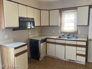 Kitchen featuring white cabinets and light counter