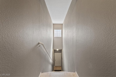 Stairway featuring a textured wall and tile patterned flooring