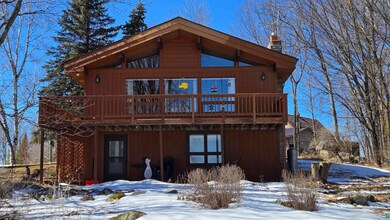 Snow covered property with a wooden deck