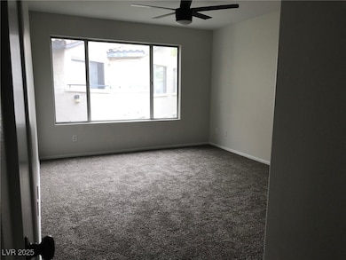 Spare room with carpet floors and ceiling fan
