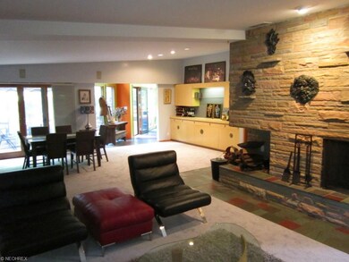 LR/DR with stone fireplace and built-in bar/server