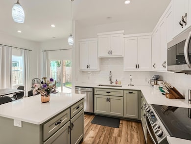 Kitchen featuring stainless steel appliances, a s