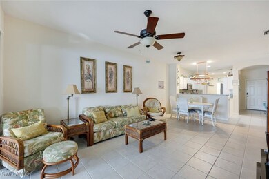Tiled living room featuring ceiling fan