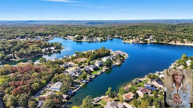 Aerial perspective of suburban area with a forest and a nearby body of water