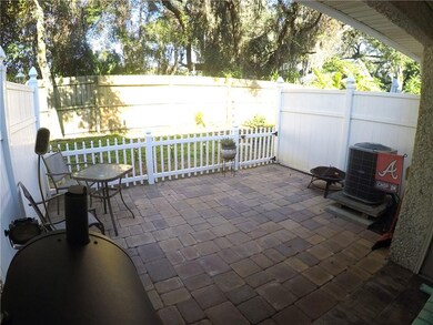 Semi covered patio area with pavers and PVC fencin