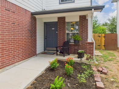 View of exterior entry featuring brick siding, a 