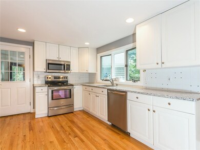Kitchen with side entrance to 3 season room that l