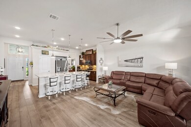 Living area with wood-finished flooring/ kitchen