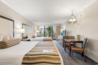 Carpeted bedroom with crown molding and a wall of windows