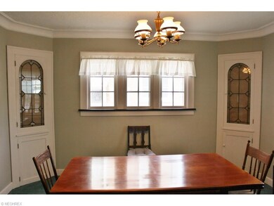 Dining room features two lovely leaded glass corne