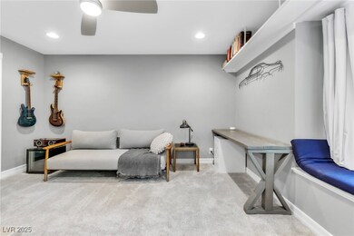 Living area featuring carpet flooring, baseboards,