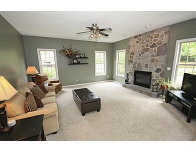 Family Room. The family room lets in lots of natural light from outside and showcases a great stone fireplace.