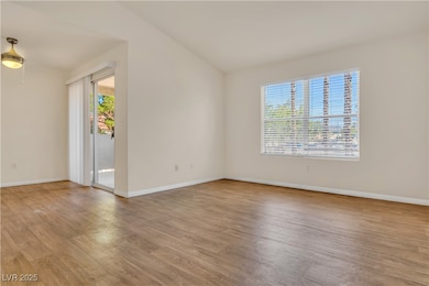 Empty room with light wood-style flooring and healthy amount of natural light